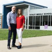 Carlos and Tatiana Ibañez stand resolute in front of their daughter’s school.